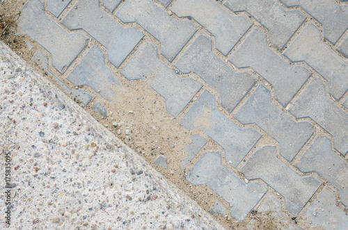 Joint of Concrete and Paving Stones from the Sidewalk. Paving stones on a footpath photo