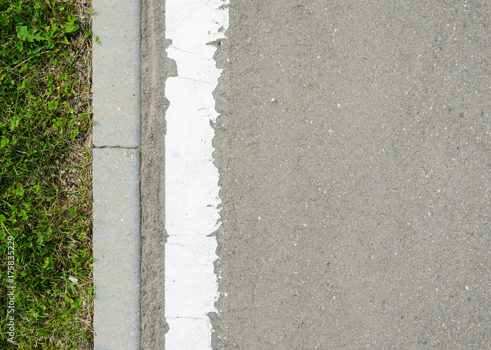 Asphalt Road with White Marking Strip and Lawn Texture. Texture of the Road Surface Element with Adjacently Pavement Curb Stone and Green Lawn Asphalt Road with White Marking Strip and Lawn Texture. Texture of the Road Surface Element with Adjacently Pavement Curb Stone and Green Lawn