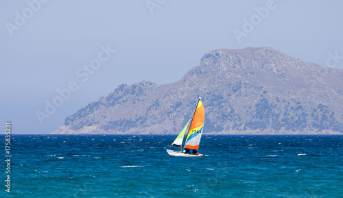 Obraz na płótnie A small sailing boat in Alcudia bay near Can Picafort town, Majorca w salonie