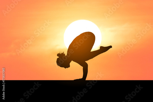 Fototapeta Naklejka Na Ścianę i Meble -  Silhouette of a beautiful Yoga woman with sun background 