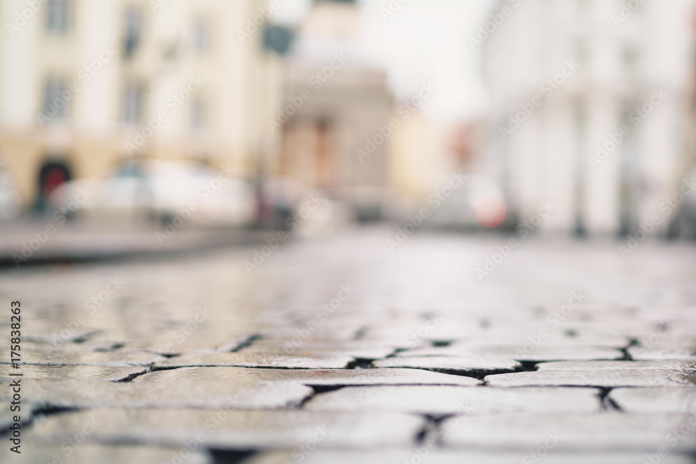 low angle shot of wet old pavement in Tallinn with shallow focus