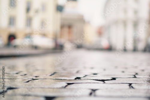 low angle shot of wet old pavement in Tallinn with shallow focus © GCapture