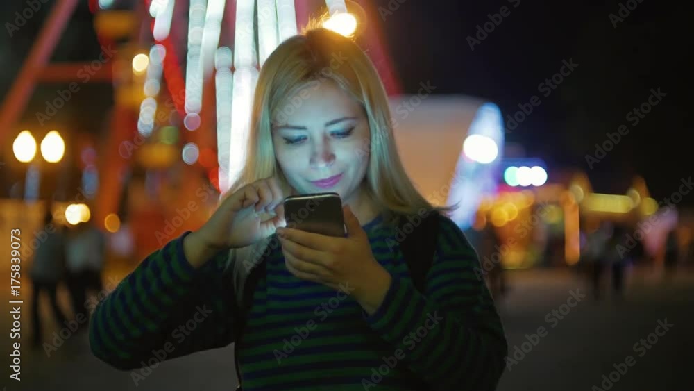 Blond hair young girl with mobile at late night park looks photos Blond hair young girl with mobile at late night park looks photos