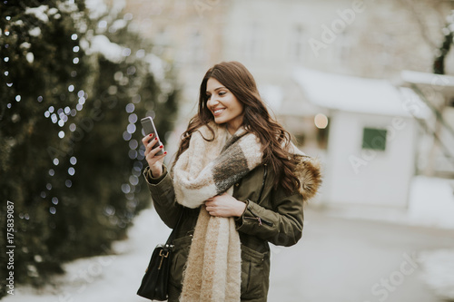 Young woman using phone in ...