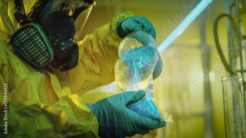 Fotografija In the Underground Laboratory Clandestine Chemists in Protective Coveralls Pack Newly Cooked Batch of Drugs in the Bags for Further Street Distribution