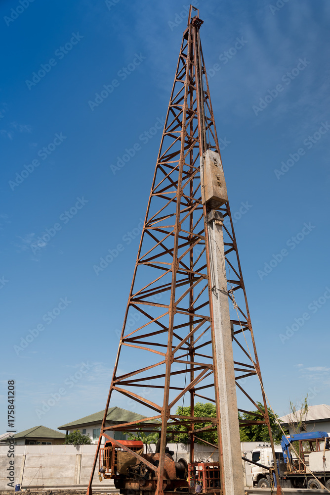 Pile driving machine in construction site. Pile driving machine in construction site.