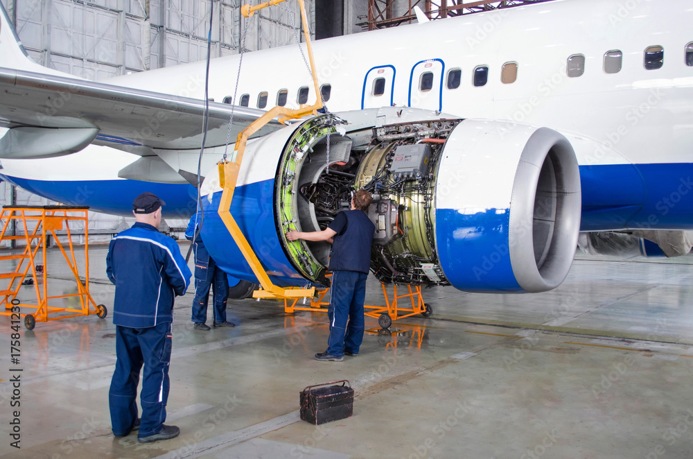 Replacing the engine on the airplane, working people. Concept