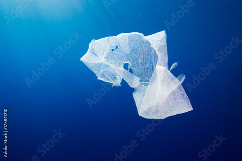 A discarded plastic bag floating in open ocean.  Plastic pollution is a rapidly growing environmental problem.
