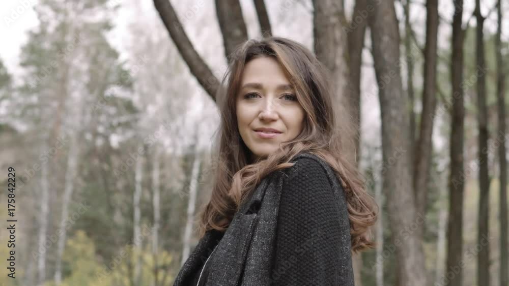 Beautiful girl walks smiling in autumn in the park Beautiful girl walks smiling in autumn in the park