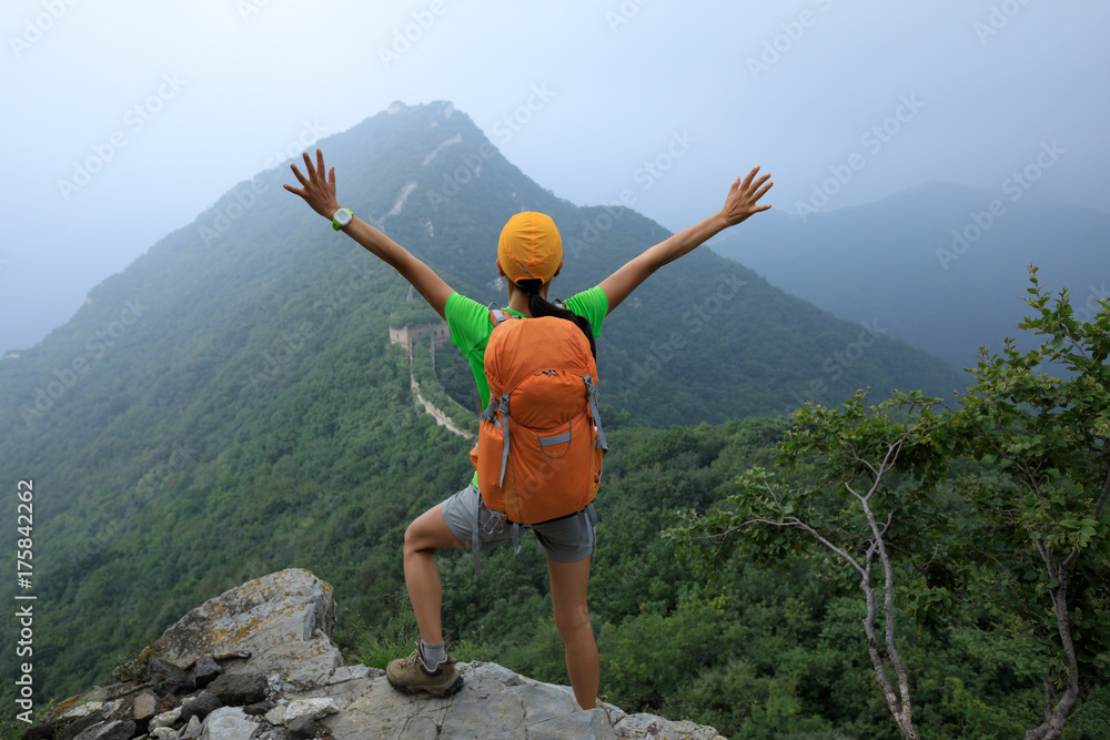 successful woman hiker open arms to the great wall on the top of mountain successful woman hiker open arms to the great wall on the top of mountain