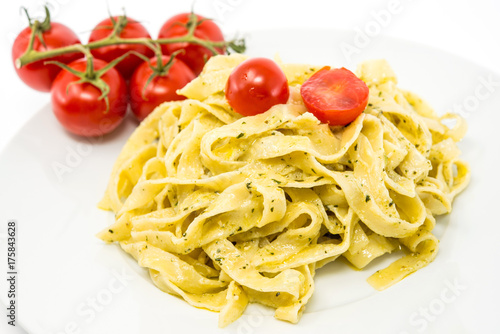 Pasta with pesto sauce and nuts on a the table