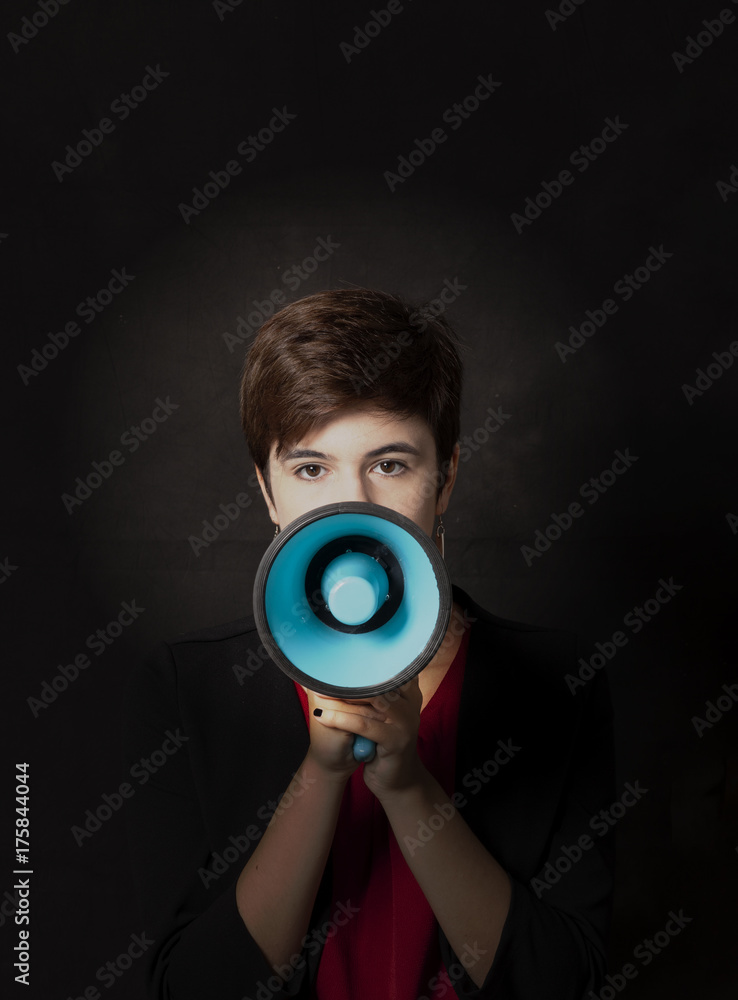 Fototapeta premium girl with megaphone on dark background
