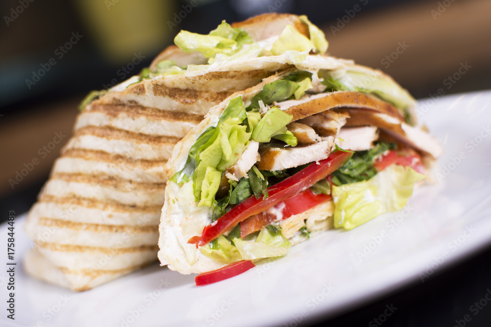 Burrito with grilled chicken and vegetables. Shawarma from juicy beef, lettuce, tomatoes, cucumbers, paprika and onion in pita bread. Burrito with grilled chicken and vegetables. Shawarma from juicy beef, lettuce, tomatoes, cucumbers, paprika and onion in pita bread.