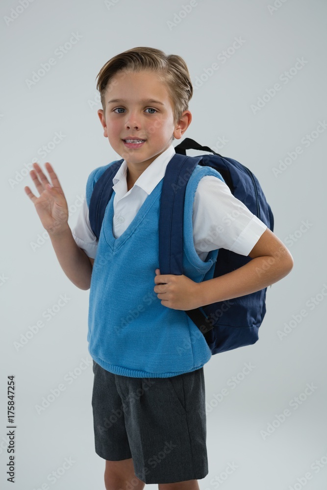 Portrait of cute school boy waving hand Portrait of cute school boy waving hand
