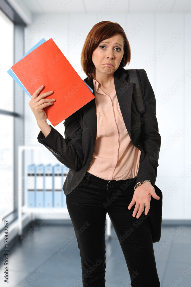 business red hair woman or student in stress thinking worried while carrying a portfolio business red hair woman or student in stress thinking worried while carrying a portfolio