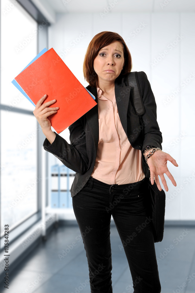 business red hair woman or student in stress thinking worried while carrying a portfolio business red hair woman or student in stress thinking worried while carrying a portfolio