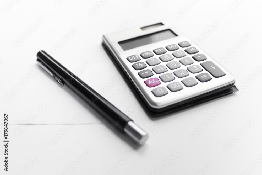 calculator with a pen and paper note with debt word isolated on white background calculator with a pen and paper note with debt word isolated on white background
