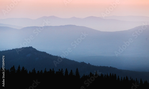 Fototapeta Naklejka Na Ścianę i Meble -  A beautiful colorful sunset in mountain ridge with glowing red haze