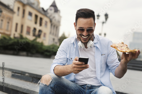 Man eating pizza cut