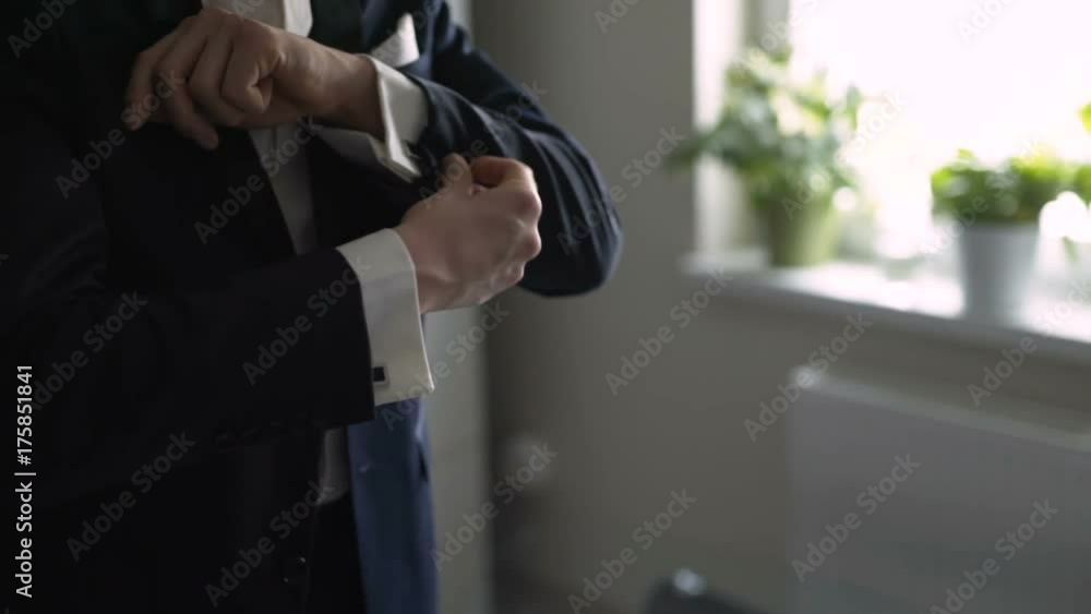Man adjusting sleeves. Man adjusting sleeves.