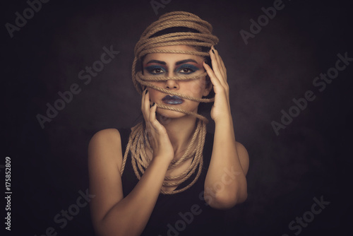 Attractive woman portrait with rope