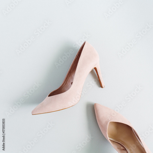 Fashion blog look. Pale pink women high heel shoes on blue background. Flat lay, top view trendy beauty female background.