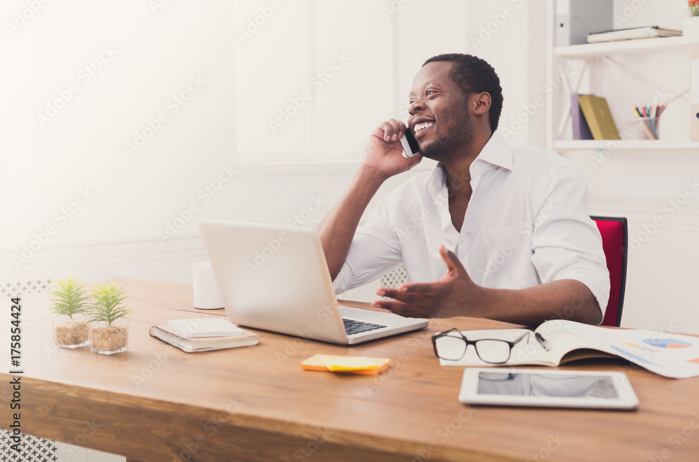 Young black businessman call mobile phone in modern white office Young black businessman call mobile phone in modern white office