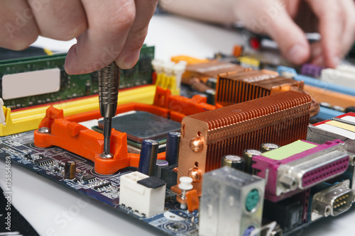 Wallpaper Mural Engineer checking motherboard with multimeter Torontodigital.ca