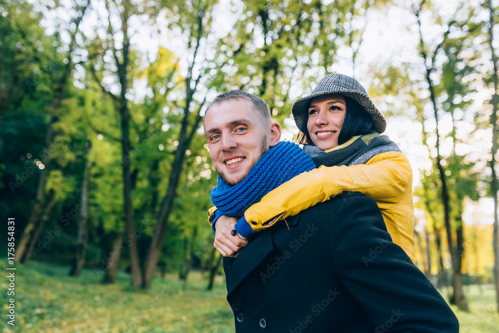 Happy Couple Having Fun in Autumn Park. Yellow Trees and Leaves. Laughing Man and Woman outdoor. Freedom Concept. Happy Couple Having Fun in Autumn Park. Yellow Trees and Leaves. Laughing Man and Woman outdoor. Freedom Concept.