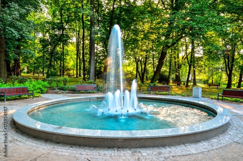 Nice fountain in the urban park. Green park in the city of Chrzanow, Poland.