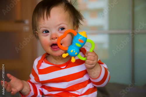 Portrait of cute baby boy with Down syndrome photo