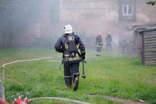 The team of firefighters eliminates the fire in an old building