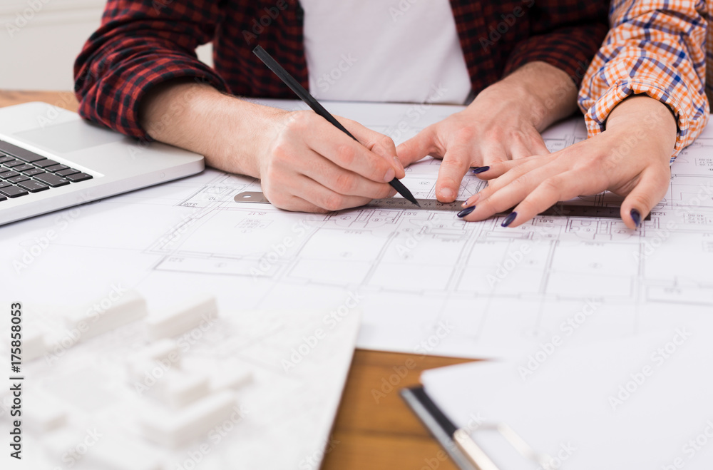 Unrecognizable architects discussing building plan Unrecognizable architects discussing building plan