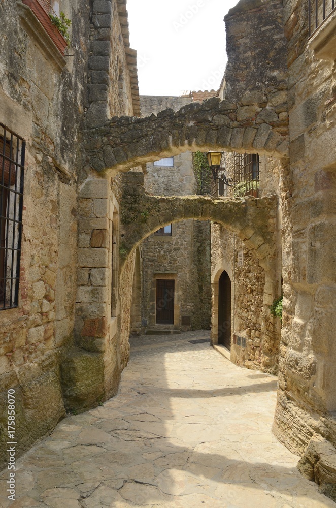 Archway  in medieval alley in Pals, Girona, Spain