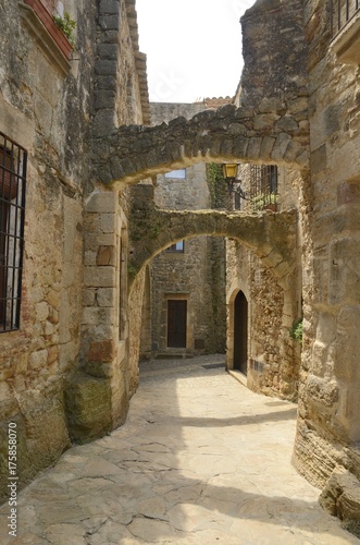 Archway in medieval alley in Pals, Girona, Spain