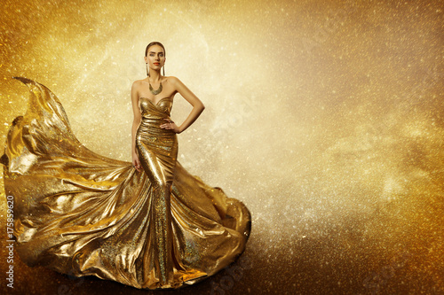 Fotografie Golden Fashion Model, Elegant Woman Flying Gold Dress, Waving Sparkling Gown Fab