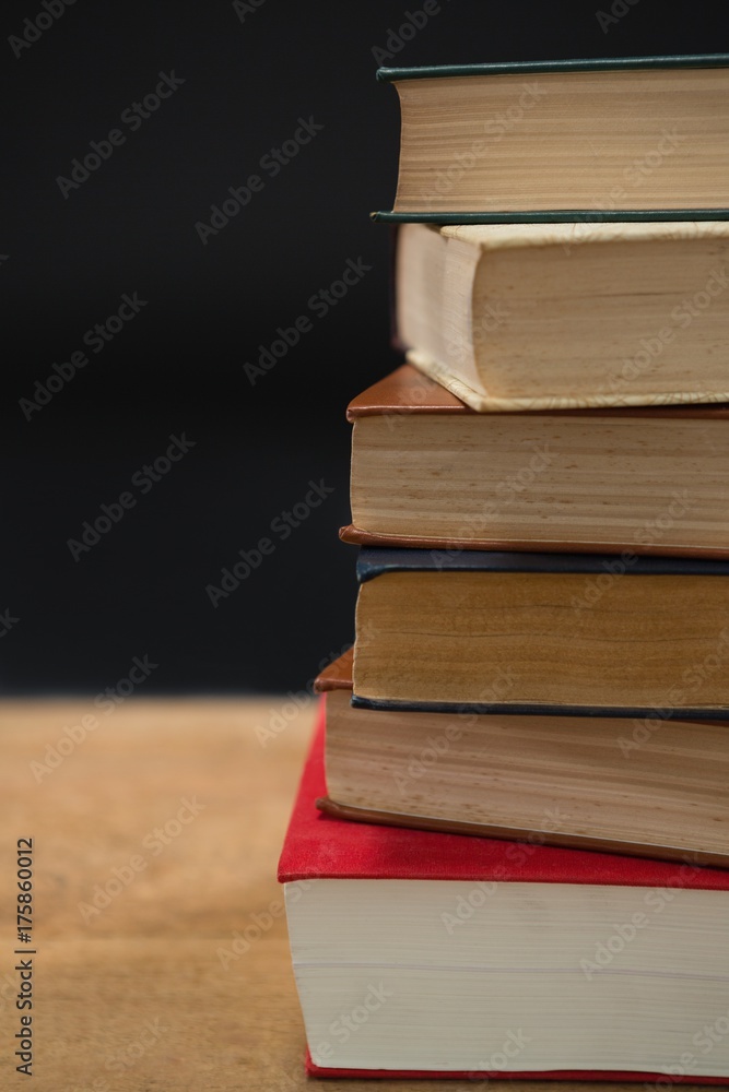 Stack of books on wooden table Stack of books on wooden table