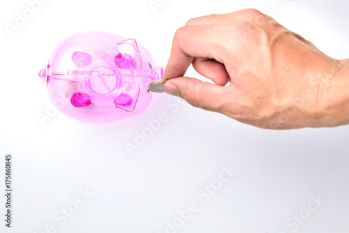 Hand Drop A Coin In Pinnk Piggy Bank on white background for money saving concept