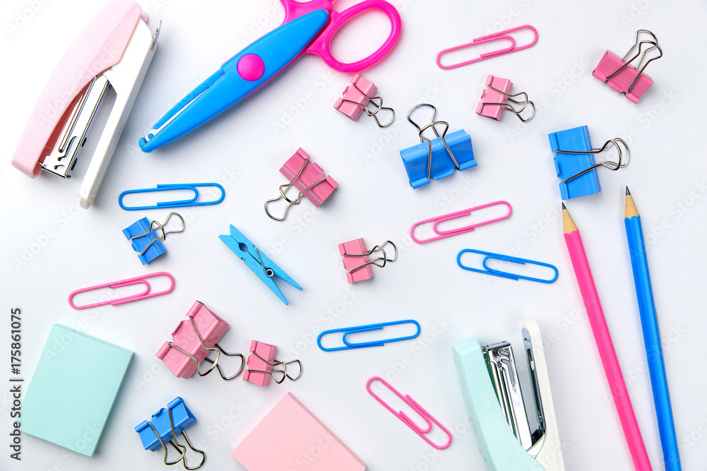 Stationary concept, Flat Lay top view Photo of Scissors, pencils, paper clips, post it,stapler in pink and blue tone on white background with copy space Stationary concept, Flat Lay top view Photo of Scissors, pencils, paper clips, post it,stapler in pink and blue tone on white background with copy space