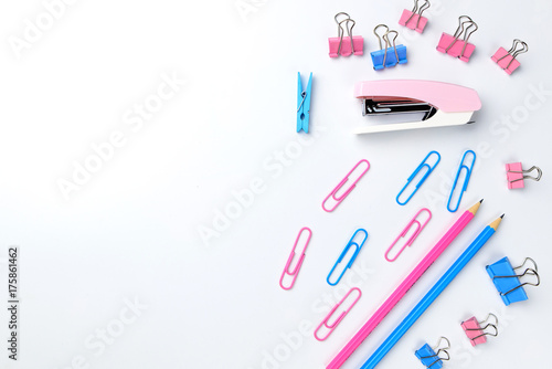 Stationary concept, Flat Lay top view Photo of Scissors, pencils, paper clips, post it,stapler in pink and blue tone on white background with copy space