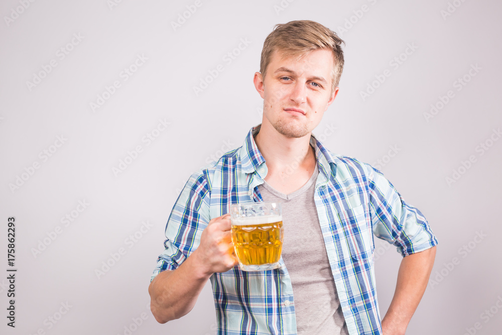 Handsome man holding a mug of beer. Handsome man holding a mug of beer.