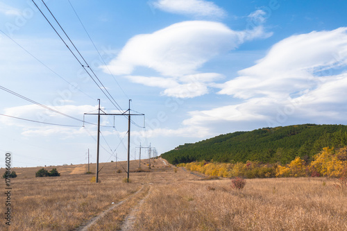 Pylons of power line in countryside / Pillars of power line in countryside