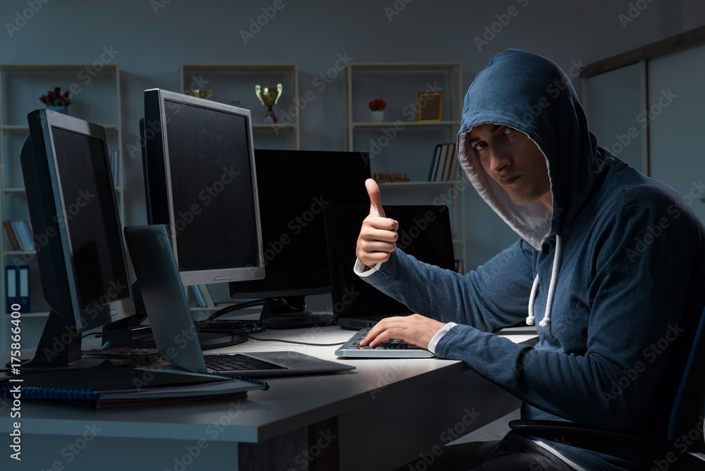 Hacker hacking computer at night Hacker hacking computer at night