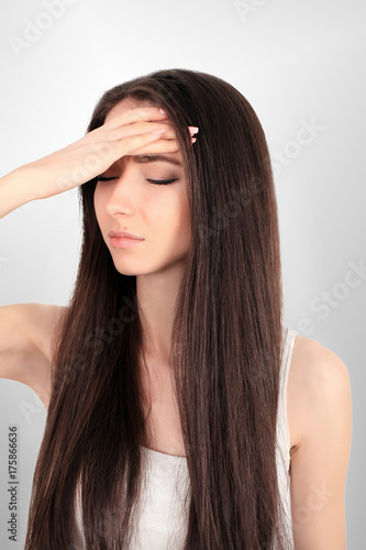 Health. Woman In Pain Feeling Bad And Sick, Having Headache And Fever, Holding Hand On Forehead. Beautiful Unhappy Tired Girl Suffering From Painful Head Ache And Stress. Healthcare. High Resolution