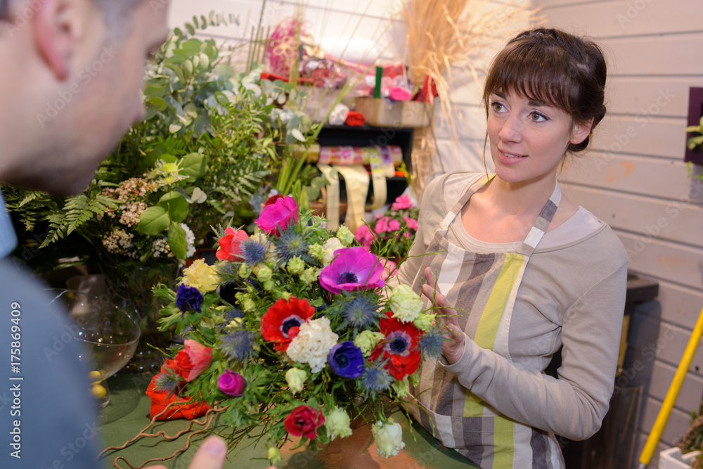 female florist working in flower section at store