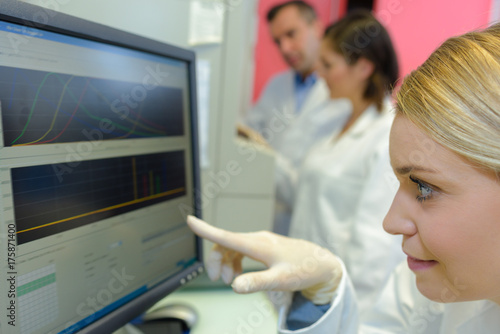 medical scientists using digital machinery at laboratory