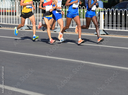 Marathon runners running on city road