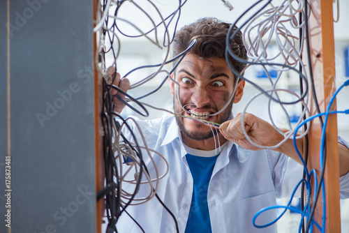 Electrician trying to untangle wires in repair concept