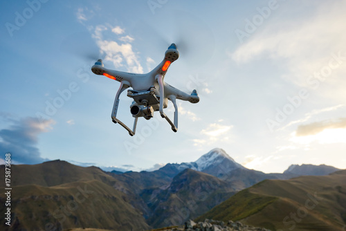 drone copter flying with digital camera in mountains