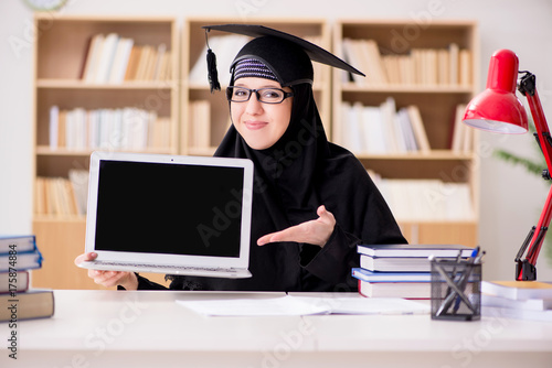 Muslim girl in hijab studying preparing for exams